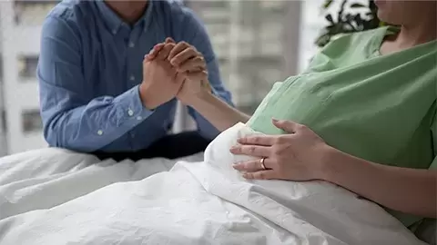 Mom sitting on hospital bed